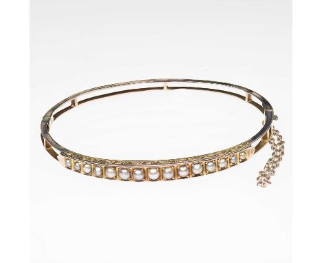 A LATE VICTORIAN SPLIT PEARL HINGE OPENING BANGLE graduated split pearls in square settings to a double bar hinge opening bac