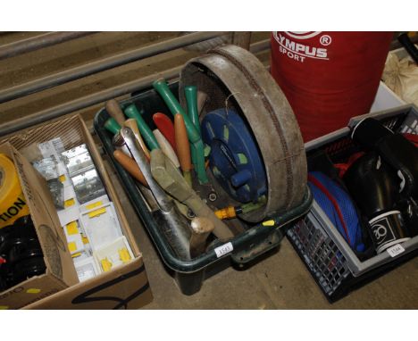 A plastic box containing various garden tools