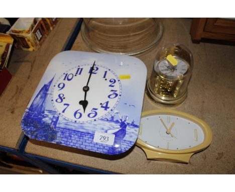 A Delft style blue and white wall clock, an alarm clock and an Anniversary clock