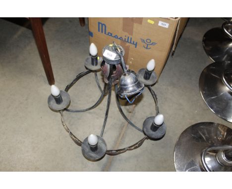 A wrought iron five branch ceiling light