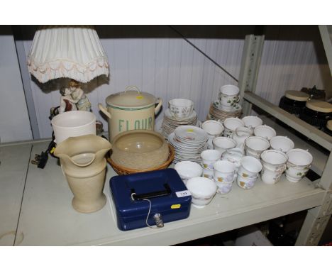 A quantity of various tea ware, an enamel flour bin, table lamp, Hillstonia vase, bowl, cash tin etc.