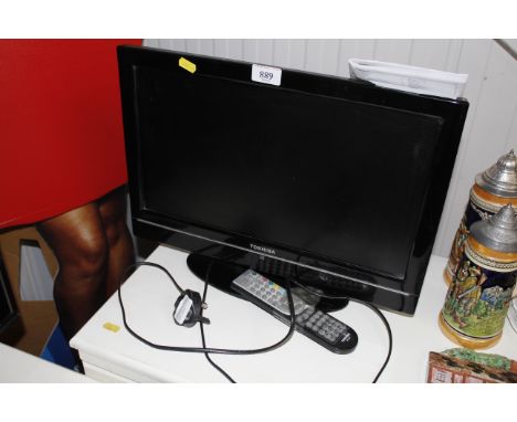 A Toshiba flat screen TV with remote control and user manual