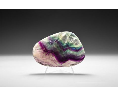 A fine flat and polished fluorite with rounded edges, bands of colour ranging from jade gree, purple and clear, with 'rainbow