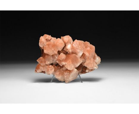 A fine specimen of a red calcite crystals with waxy lustre on a matrix, in white card tray.  363 grams, 11cm (4 1/4"). From a