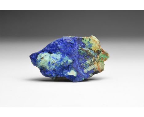 A matrix specimen of crystalline azurite with dark blue colour with minor malachite, in white card tray; from Arizona, USA.  