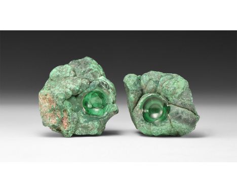A group of two fine malachite specimens, each with a polished recess showing bands of pale and dark green colour.  233 grams 