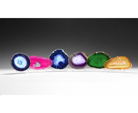 A group of six cut and polished agate slices with bands of purple, blue, green, purple and brown colour, some with honeycomb 