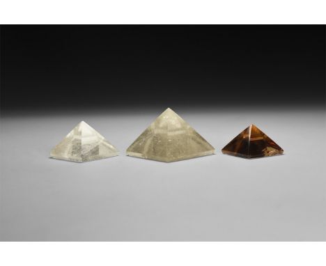 A group of three finely cut pyramids, one smoky quartz and two rutilated quartz.  114 grams total, 29-43mm (1 1/4 - 1 3/4"). 