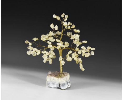 A medium size gemstone tree consisting of a brass trunk and branches tipped with polished rock crystals, mounted on a section