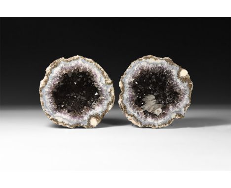 A cut geode with band of pale blue agate border and clusters of amethyst crystals with inclusions.  1.21 kg total, 10.7cm (4 