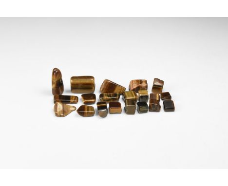 A group of twenty polished tiger's eye slices showing silky lustre and bands of colour.  54 grams total, 9-27mm (1/4 - 1"). F