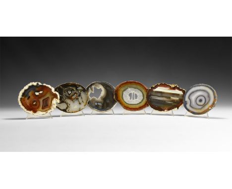 A mixed group of six cut and polished banded agate slices, some with central hole filled with crystals.  343 grams total, 8.8