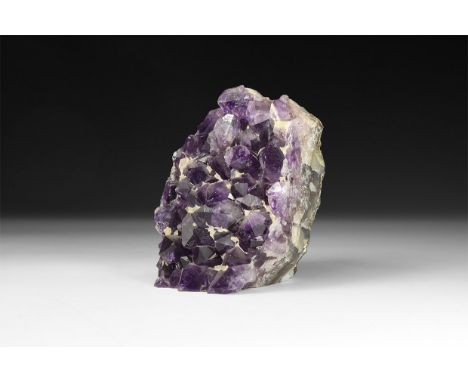 A fine specimen of deep purple amethyst crystals on a cut matrix.  1.2 kg, 11.2cm (4 1/2"). From a historic ‘Victorian Museum