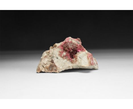 A fine specimen of a dark pink roselite crystals on a matrix, in white card tray and an old label reading: 'Roselite, Bou Azz
