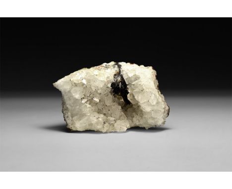 A fine specimen of specular haematite section on a quartz crystal matrix, in white card tray.  390 grams, 90mm (3 1/2"). From