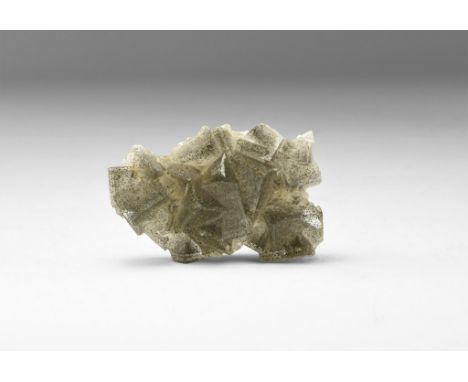 A fine example of pale grey fluorite with hematite 'flakes' to the surface, in a white card tray with label reading 'FLUORITE