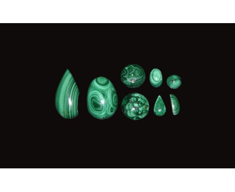 A mixed group of eight malachite carvings with bands of dark and pale green colour.  66 grams total, 13-43mm (1/2 - 1 3/4"). 
