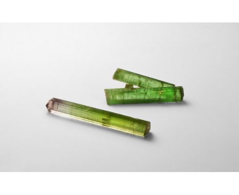 A group of two fine columns of tourmaline, one with green and pink colour bands, one of two joined green columns; in white ca