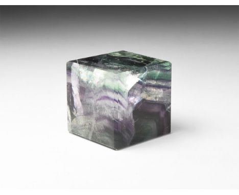 A cut and polished cube of fluorite with bands of green and purple colour.  135 grams, 35mm (1 1/2"). From a historic ‘Victor