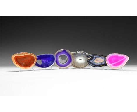 A group of six cut and polished banded agate slices of blue, pink, purple and orange colour, some with central cavity.  304 g