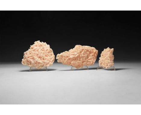A group of three pink dolomite labs with saddle-shaped crystal crust mass.  450 grams total, 7-13.5cm (2 3/4 - 5 1/4"). From 