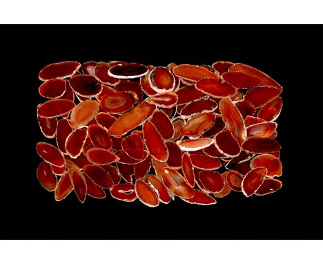 A group of one hundred cut and polished red agate slices, colour enhanced.  579 grams total, 36-59mm (1 1/2 - 2 1/4"). From a
