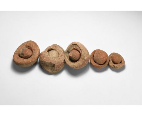Group of five wind-rounded pebbles with their individual hollowed out 'nests', from the Kalahari Desert region, western Afric