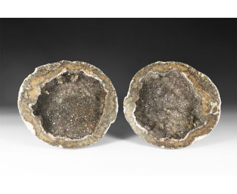 A pair of cut and polished geode halves, with grey quartz crystals to the void.  1.7 kg, 14-14.5cm (5 1/2 - 5 3/4"). From a h