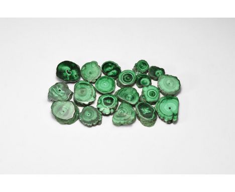 A group of nineteen cut and polished circular malachite specimens, most with concentric bands of pale and deep green colour; 