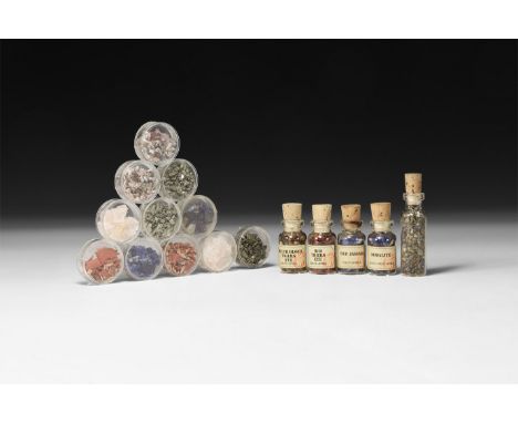 A mixed group of small polished specimens of tigers eye, sodalite, rose quartz and pyrite; five groups in miniature glass bot