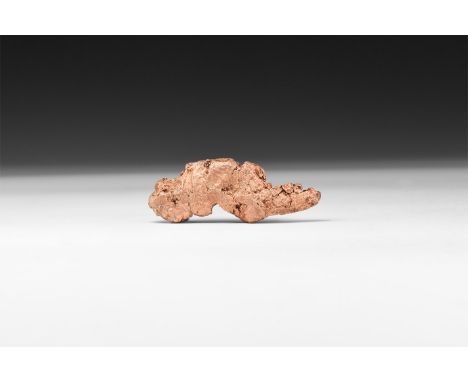 A specimen of a 'float copper' of a coopery pink colour with small areas of inclusions, in white card tray with label reading