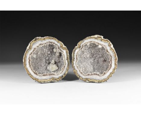 A cut and polished pair of geode halves with quartz crystals in the void.  806 grams total, 99-103mm (4"). From a historic ‘V