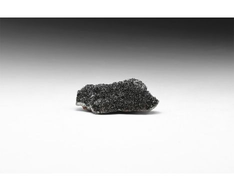 A fine specimen of specularite, or specular hematite, in white card box with label reading: Specularite with quartz, Florence