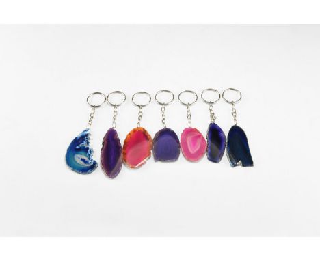 A group of seven cut and polished agate slices of pink, purple and blue colour; each with short chain suspender and split key
