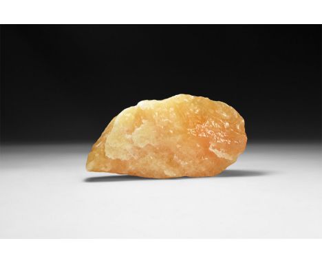 An irregular orange calcite specimen, with typical waxy surface.  946 grams total, 17cm (6 3/4"). From a historic ‘Victorian 