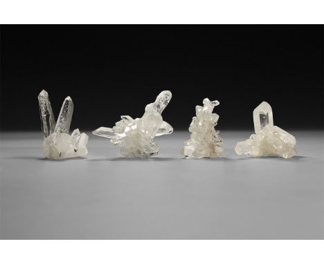 A group of four formations of transparent quartz crystals, in two white card box.  136 grams total, 45-57mm (1 3/4 - 2 1/4").