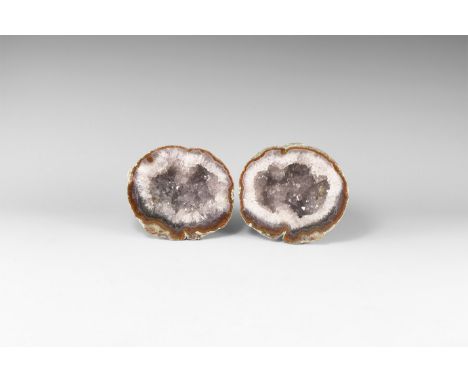 A pair of cut and polished geode with band of orange agate and pale purple amethyst crystals to the centre.  1.21 kg total, 1