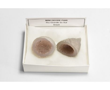 A fine specimen of a cut mini geode filled with miniature white crystals, in white card box with label reading: 'Mini geode p
