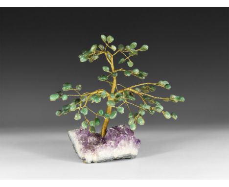 A medium size gemstone tree consisting of a brass trunk and branches tipped with polished green agate mineral specimens, moun