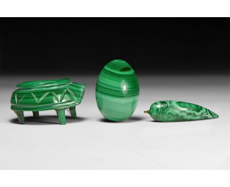 A group of three green banded malachite carvings, comprising of an egg, a claw-shaped pendant and bowl on feet.  247 grams to