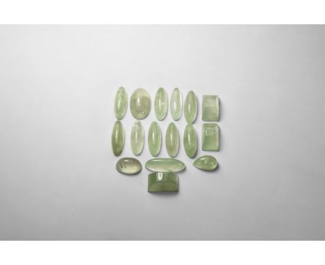 A group of pale green prehnite cabochon-cut and other types in a collector's card tray.  49 grams, 16-26mm (1/2 - 1"). From a
