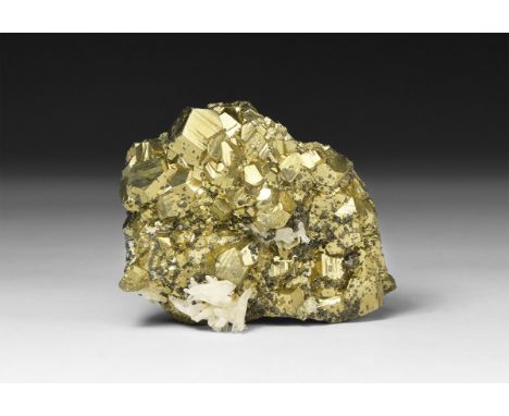 A fine specimen of lustrous pyrite (Fool's Gold) with white quartz crystal formations to the surface, in white card tray with