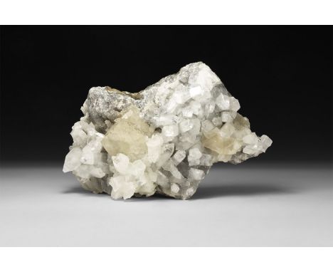 A large formation of two pale yellow cubic calcite crystals among white quartz crystals on a matrix.  2.87 kg, 22cm (8 1/2").