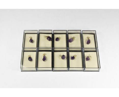A group of ten amethyst points with electroform mounts and suspension rings; each in a perspex display box.  155 grams total,