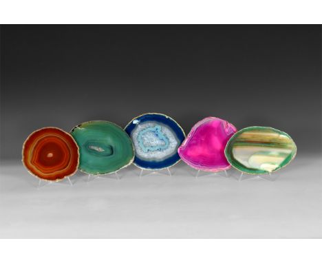 A group of five cut and polished agate slices showing a range of colour, some with honeycomb crystals and enhanced colours.  