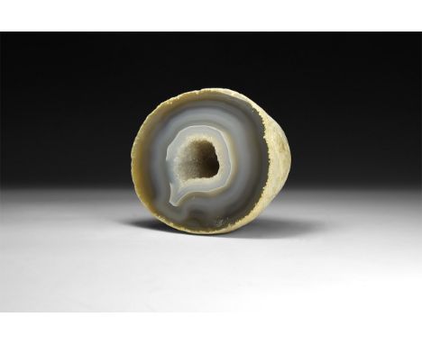 A fine agate geode half with layers of blue bands with central cavity filled with miniature white quartz crystals.  1.2 kg, 1