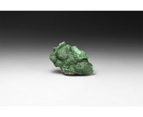 A large fine specimen of malachite with a coating of bright green crystal, in white card tray with label reading: 'Crystallin