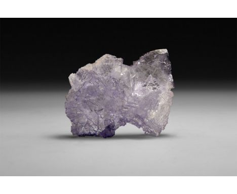 A fine specimen of a pale purple fluorite, in white card tray with label reading: 'Fluorite, Tri-State, USA'.  141 grams, 70m