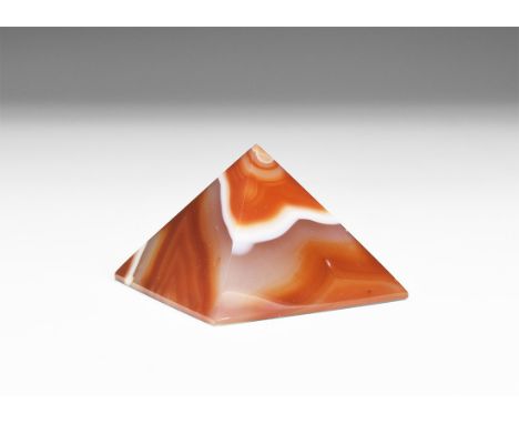 A finely cut and polished white and orange agate pyramid, in white card tray, possibly colour enhanced.  81 grams, 49mm (2").