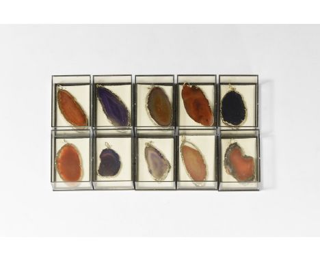 A group of ten polished agate slices pendants with gold-coloured metal caps, all in plastic presentation boxes.  206 grams to